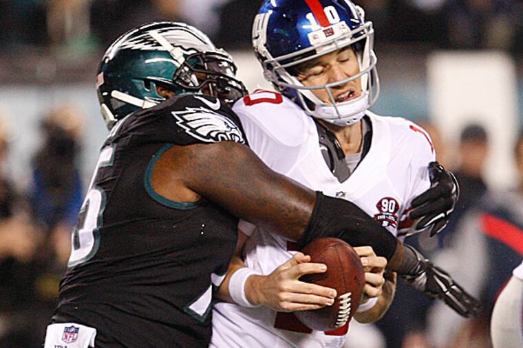 Eagles linebacker Trent Cole sacks Giants quarterback Eli Manning. (Ron Cortes/Staff Photographer)