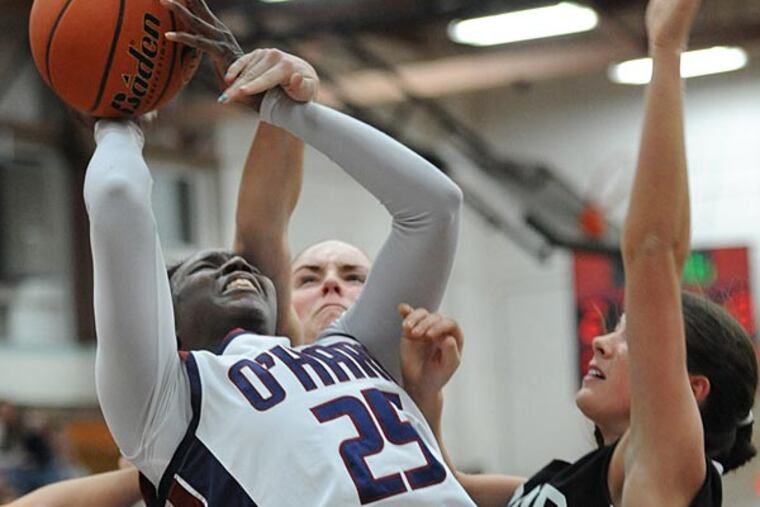Cardinal O'Hara's Shanice Johnson is fouled by Archbishop Wood's
Aubree Brown (behind) as she goes for a layup during the game at
O'Hara Jan. 25, 2013. John made one of the two free throws en-route to scoring a game high 11 points in leading O'Hara to victory 30-27. At
right is Wood's Jess Kaminski. (Clem Murray/Staff Photographer)