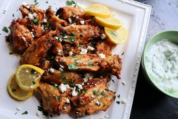 Greek-style wings are marinated in lemon, garlic and oregano and served with crumbled feta and tzatziki sauce.
