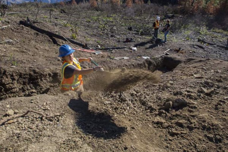 Brian Sherrod, right, points out an earthquake fault to other geologists in Spencer Canyon on November 7, 2014, at the site near Entiat, Wash., where geologists hope to find the epicenter of an 1872 quake. (Ellen M. Banner/Seattle Times/TNS)