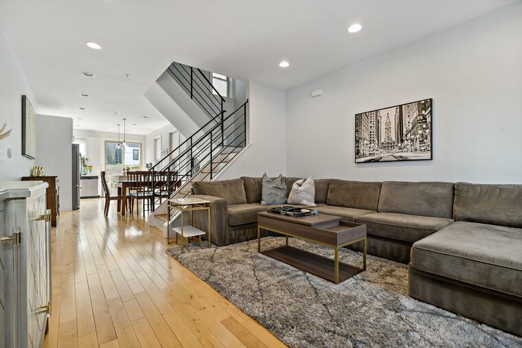 The first floor has an open living and kitchen layout with hardwood floors throughout.