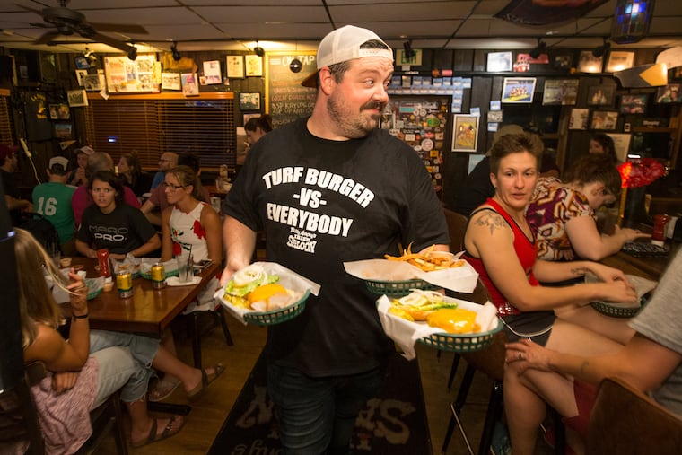The burgers being carried by Christian Hess at Billy Murphy's Irish Saloon catch the attention of Lucia Pattullo on Aug. 13, 2019.