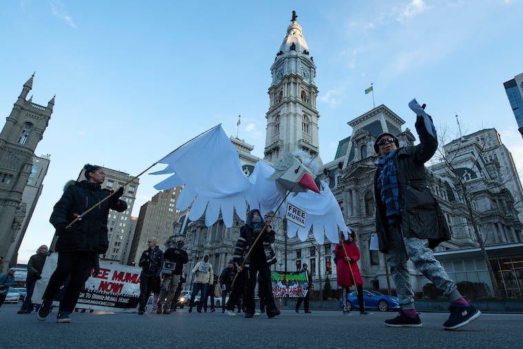 Mumia Abu-Jamal supporters passed by City Hall on Friday, Feb. 28, 2020, as they marched from the Philadelphia District Attorney's Office toward the Pennsylvania Attorney General's Office in Center City.