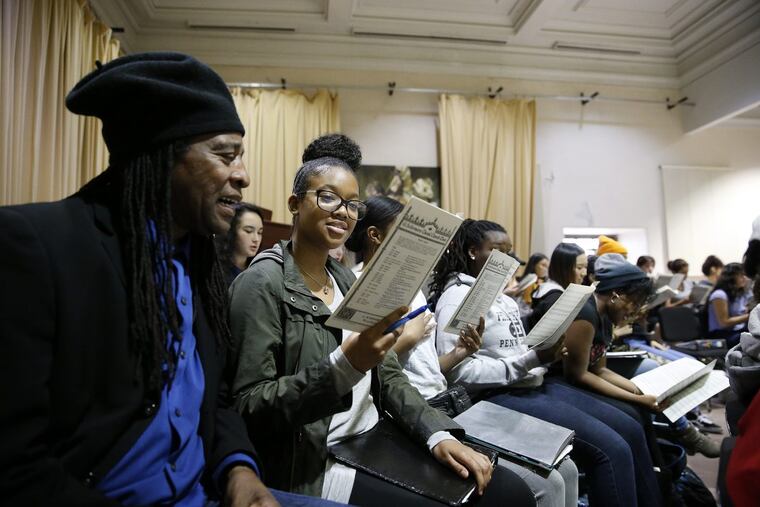 Composer Hannibal Lokumbe, left, sings with 10th grader, Aliyah Taylor, right, during his visit to the Creative and Performing Arts High School in Philadelphia on May 30, 2017.
