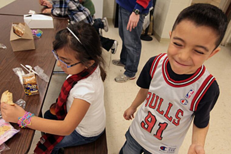 First-grade Brady Elementary School students Wendy Sanchez, left, and Andrick Mondragon enjoy an afternoon meal at their Aurora, Ill. school, January 10, 2011. (Antonio Perez/Chicago Tribune/MCT