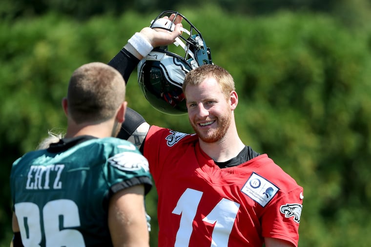Carson Wentz talks with Zach Ertz during practice on Tuesday.