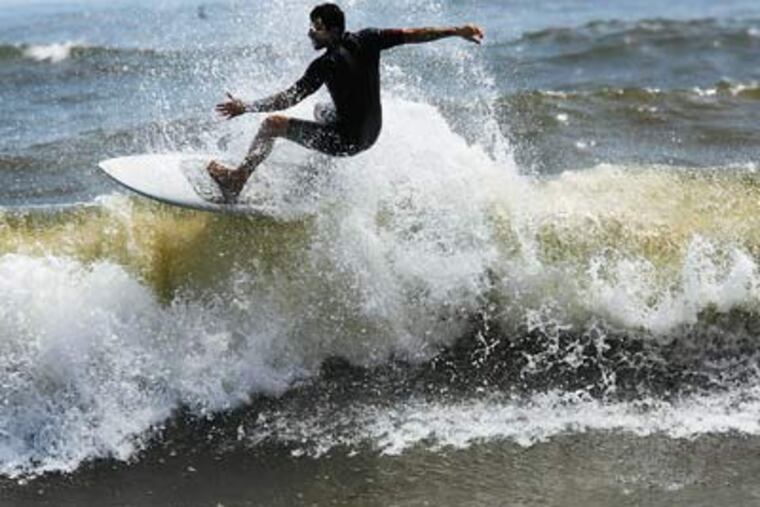 Jeff Corcory surfs in Ocean City on Thursday. The surf grew higher as Hurricane Earl moved closer to shore. ( Michael S. Wirtz / Staff Photographer )