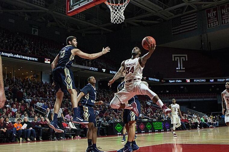 Temple's Devin Coleman jumps around defenders to put up two points. (Chris Fascenelli/Staff Photographer)
