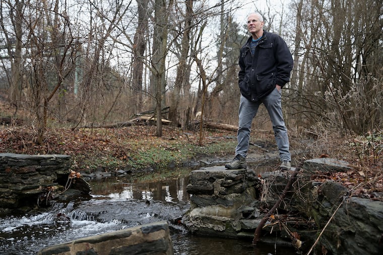Adam Levine, a historical consultant for the Philadelphia Water Department, stands for a portrait next to Mill Creek at Merion Botanical Park in Lower Merion, Pa., on Friday, Feb. 8, 2019. Levine is giving a talk about the history of the city's sewer system.
