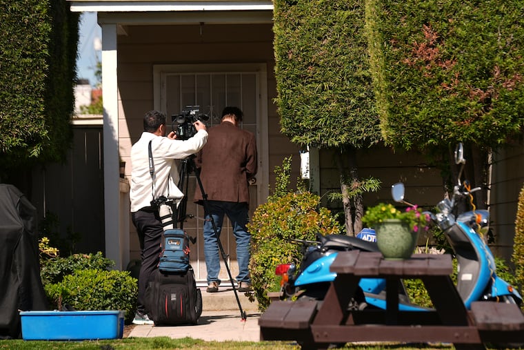 A reporter and videographer stand outside the door of a house connected to Cole Tomas Allen, who has been identified as a suspect in a shooting at the White House Correspondents Dinner early Sunday, April 26, 2026, in Torrance, Calif.