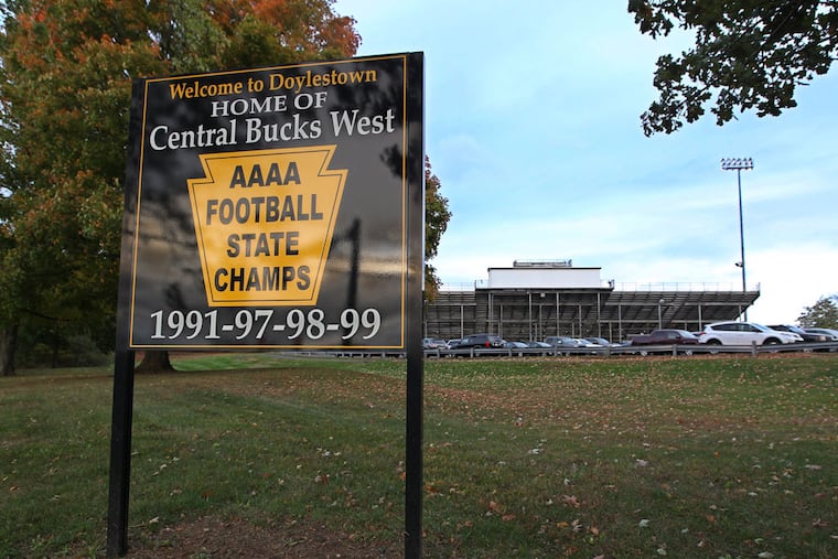 A sign in front of the Central Bucks West stadium heralds the football team's state championships.