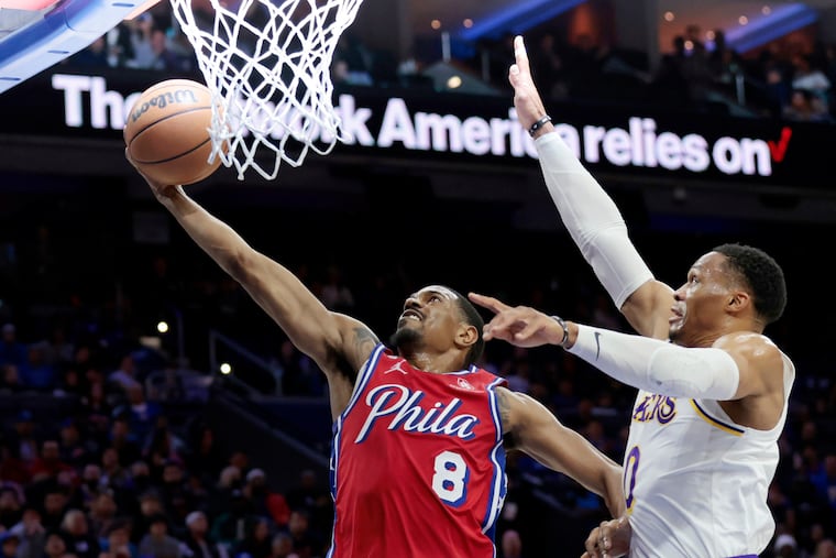 De’Anthony Melton laying up the basketball after driving by the Lakers' Russell Westbrook on Friday.