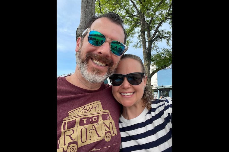 Brian and Ashlee Jaffe pose for a photograph along the July 4th parade route in Highland Park, Ill. Ashlee was shot in the hand and crawled under a bench with her son.