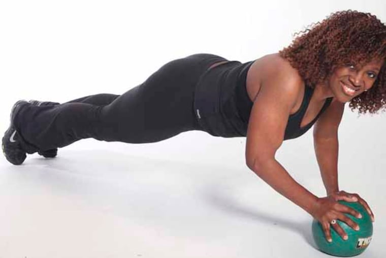 Kimberly Garrison exercise photos, Medicine Ball 2 hand triceps push-ups , Monday, March 25, 2013. ( Steven M. Falk / Staff Photographer )