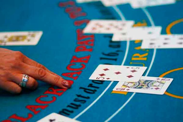 A dealer hands out cards at the blackjack table.( Michael S. Wirtz / Staff Photographer ).