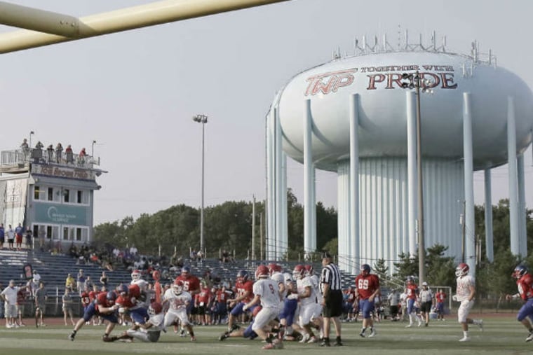 Washington Township High battles Lenape. In 1988, school helmets featured the letters TWP, and the letters caught on. (Elizabeth Robertson / Staff Photographer)