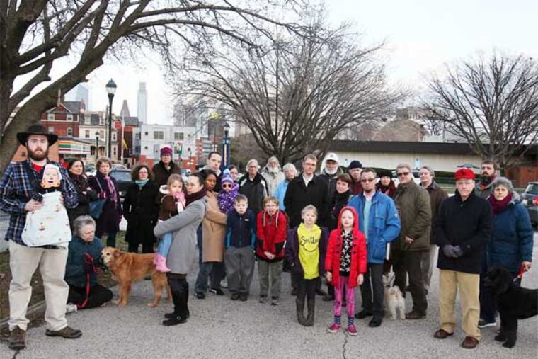 Drexel University is planning to build a high-rise residence hall at 34th and Lancaster, but neighbors oppose parts of the plan. Some of the Powelton Village Civic Association members meet at the proposed site Wednesday, March 20, 2013. (Steven M. Falk / Staff Photographer)