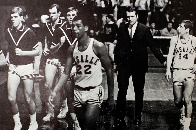 Former Temple and Penn coach Fran Dunphy (14) playing for Tom Gola (in suit) at La Salle in 1968-69.