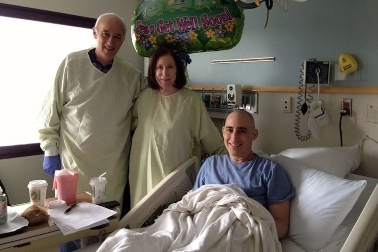 Dr. Keith Eaton, who suffered from leukemia, poses for a photo with his parents following his bone marrow transplant. He says he ran up medical bills of $500,000 when he participated in a clinical trial of CAR T cells in 2013.