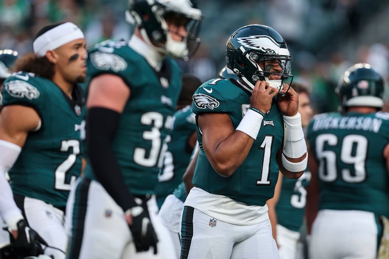 Quarterback Jalen Hurts pulls on his helmet before the Eagles played the Dallas Cowboys on Sunday, November 5, 2023 in Philadelphia.