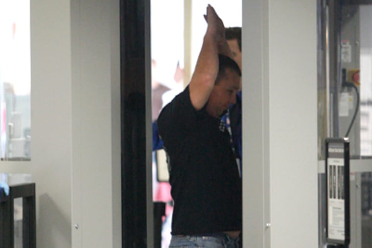 Davey Hall of Rowlett, Texas, gets a full-body scan in Terminal F at Philadelphia International Airport. (Alejandro A. Alvarez / Staff Photographer)