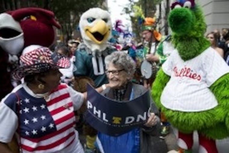 In a 2014 photo, Pearl Carpel, center, and Yvonne Cobb, left, wait with Philadelphia sports mascots to greet Democratic National Committee representatives, who were considering where to hold their 2016 convention. Ms. Carpel was a regular at public events in Philadelphia. MATT ROURKE / AP FILE PHOTO