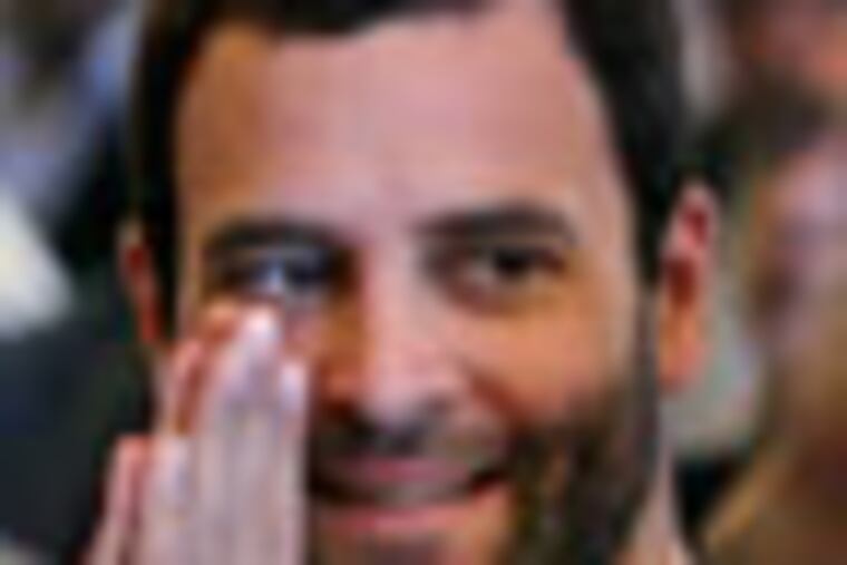 Congress party leader Rahul Gandhi greets a person, unseen, as he attends the swearing-in ceremony for the new ministers in New Delhi, India, Sunday, Oct. 28, 2012. India's Prime Minister Manmohan Singh reshuffled his Cabinet on Sunday in a bid to overhaul his government's image ahead of state and national elections over the next 18 months. Gandhi, a scion of the India's politically powerful Nehru-Gandhi family, is the son and grandson of two prime ministers. He is presumed to be a prime minister-in-waiting, but so far he has held no government positions.(AP Photo)