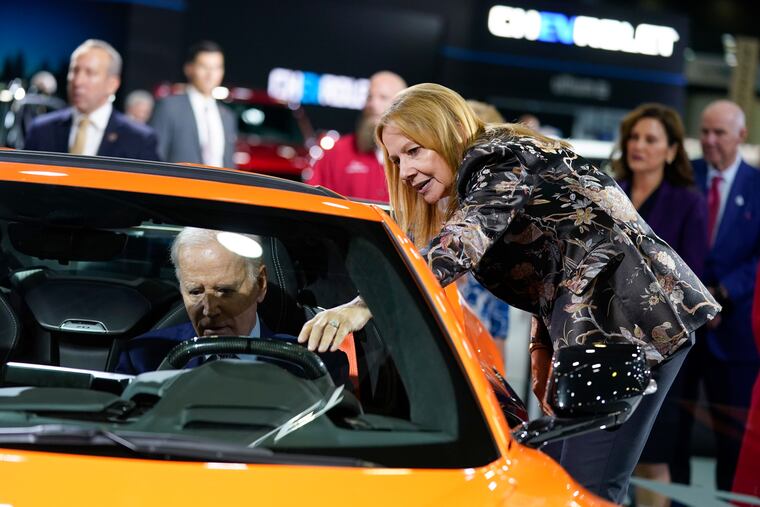 Mary Barra, CEO of General Motors, talks with President Joe Biden as he sits in a Corvette during a tour of the Detroit Auto Show last year.