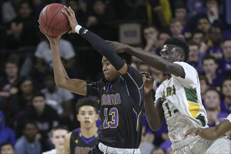 Roman Catholic Hakim Hart 13) grabs a pass in front of Bonner-Prendergastss Ajiri Johnson in last years Catholic League championship game.