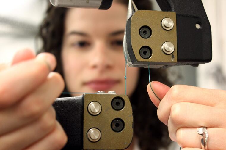 Julie Miller, a project engineer for ECRI Institute, tests the strength of a suture in ECRI's device-testing laboratory.
