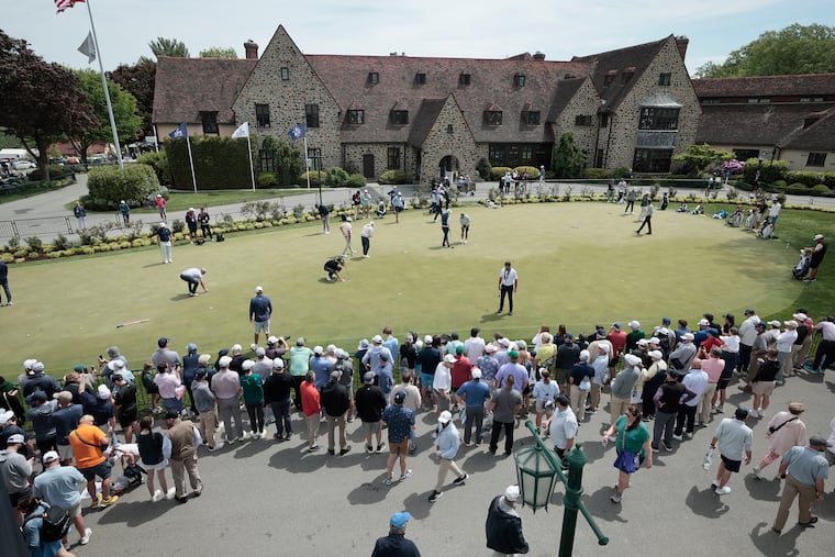Golfers practice on the putting green during the final practice round before the PGA Championship at Aronimink Golf Club on Wednesday. The greens might become more challenging in the next few days, a meteorologist suggests.