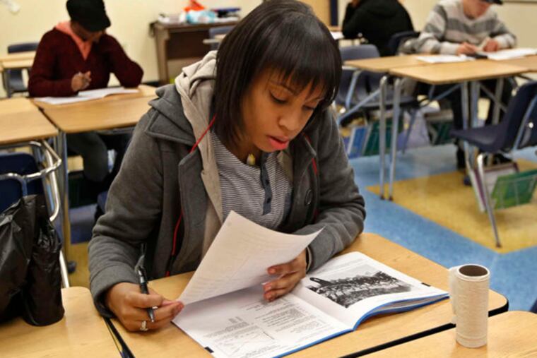 Samantha Mondesir takes the social studies part of the GED at the Harambee charter school. Many students have rushed to take the test before it is replaced.