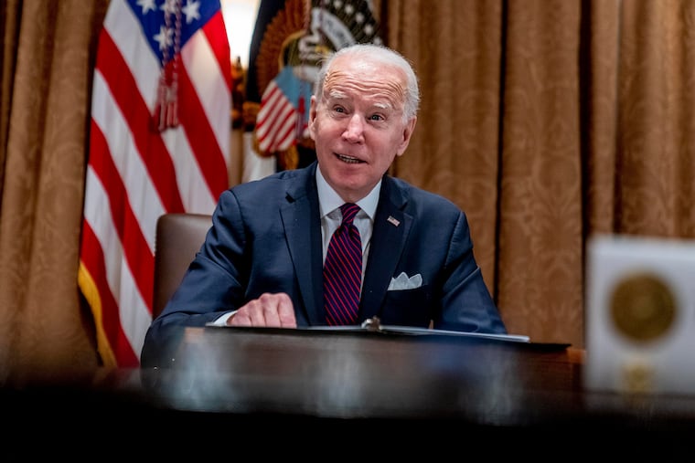 President Joe Biden meets with members of the Infrastructure Implementation Task Force to discuss the Bipartisan Infrastructure Law, in the Cabinet Room at the White House in Washington, Thursday, Jan. 20, 2022. The Biden administration is announcing policy changes to attract international students specializing in science, technology, engineering and math. It's part of the broader effort to make the U.S. economy more competitive.