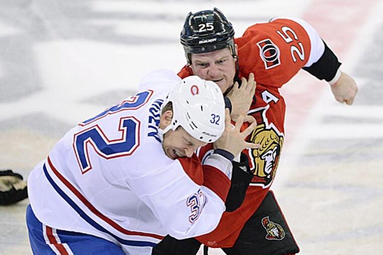 The Senators' Chris Neil fights with the Canadiens' Travis Moen in the first period. (Sean Kilpatrick/The Canadian Press/AP)