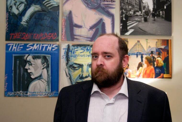 Images on the wall of Chris Morran's home in South Philadelphia reflect his interests in Philadelphia and rock music. He sprinkles his articles with local references.