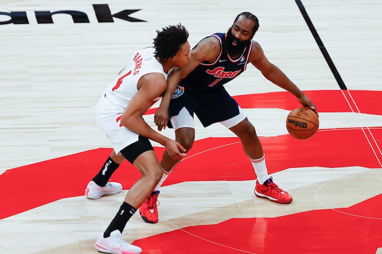 Sixers guard James Harden is guarded by Toronto Raptors forward Scottie Barnes during Game 6 of their playoff series in April.