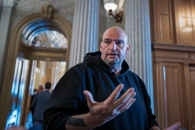 Sen. John Fetterman, D-Pa., meets with reporters at the Capitol in Washington in March.
