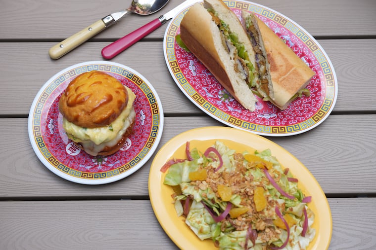 Clockwise from top: The eggplant empanizado sandwich, ensalada fresca, and the Chino breakfast sandwich at Chibanos, 1127 Pine St.