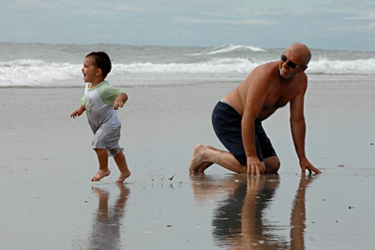 Dominic Polidoro from Wenonah, and grandfather, Wallace Whittaker, enjoy the surf in North Wildwood. (Inquirer file photo)