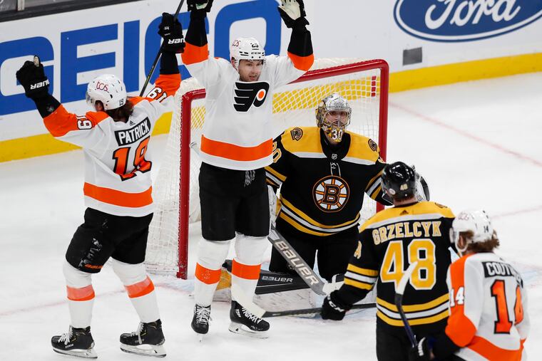 James van Riemsdyk (center) and Nolan Patrick celebrated Sean Couturier's clutch third-period goal on Monday.