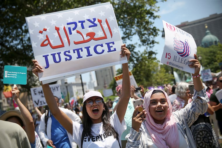 Audrika Khondaker, left, and her friend Afra Anan, both of Breinigsville, Pa., cheer during a protest against the Trump administration's separation and detention of immigrant families at Logan Square in Philadelphia in June 2018. Ahead of the November election, Philadelphia activist groups are planning to mobilize protesters in the event of electoral discord.