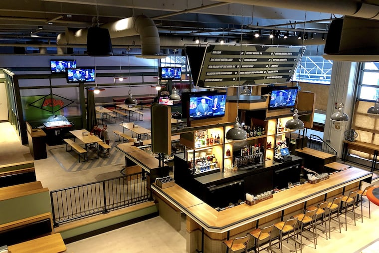 As viewed from a 10-foot balcony, the front and rear bars and game room at The Post, 129 S. 30th St.