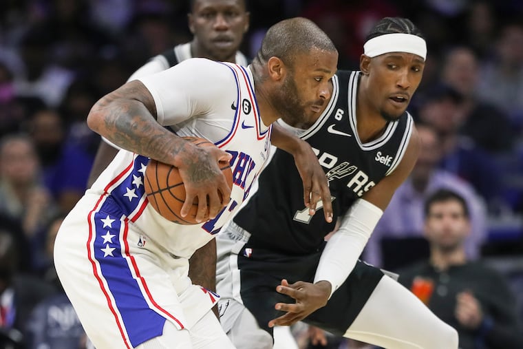 Sixers forward P.J. Tucker pulls in a rebound as San Antonio Spurs guard Josh Richardson defends at the Wells Fargo Center.