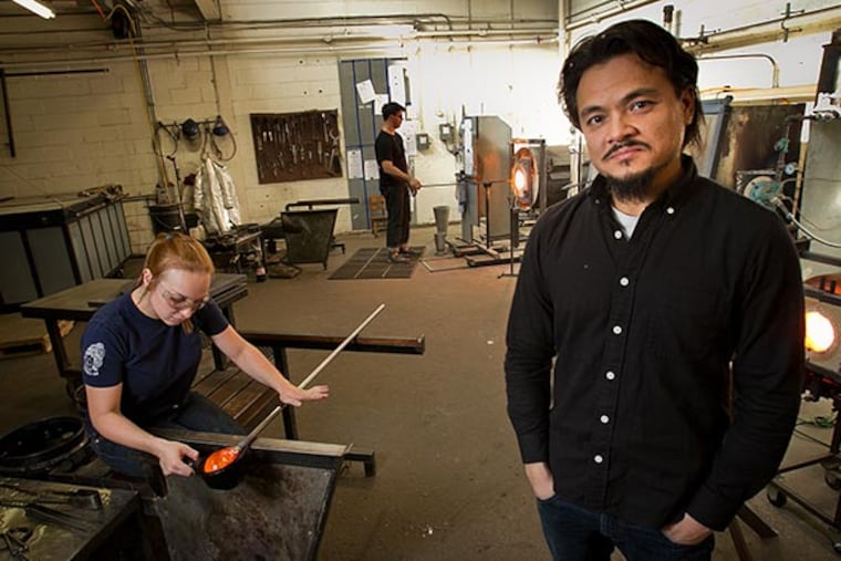 John Pomp of John Pomp Studios in Philadelphia. He runs a small business that uses blown glass to make lighting. Photograph taken in the hot shop on Monday, November 25, 2013. ( ALEJANDRO A. ALVAREZ / STAFF PHOTOGRAPHER )