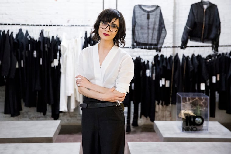Bela Shehu, owner and creative designer of NINObrand, poses with her fashions at Private School: a retail event that Shehu launched on April 25, 2019. The month long pop up in Spring Arts will feature over eighty artists. (RACHEL WISNIEWSKI / For the Inquirer)