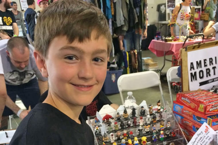 Axel Bond, 9, peddles his figurines. (DYLAN SEGELBAUM / DAILY NEWS STAFF)