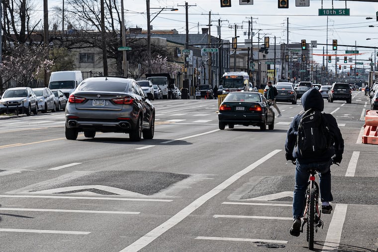 A cyclist travels on the bike lane along 18th Street and Washington Avenue in 2024, a year after the completion of the traffic calming Washington Avenue Improvement Project.