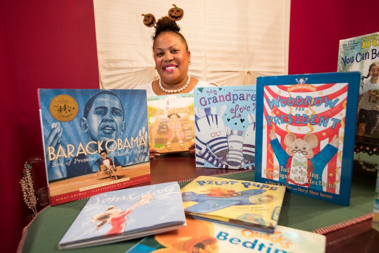 Sherry Knight, Principal of the Captain James Lawrence Elementary School in Burlington City, wanted to help her students improve their reading skills. So she reads to them herself - bedtime stories via Facebook. Knight has slowly gained an audience since she started the project at the end of the 2018-19 school year. She is shown with a selection of book donated by Scholastic Books on Oct. 23, 2019.