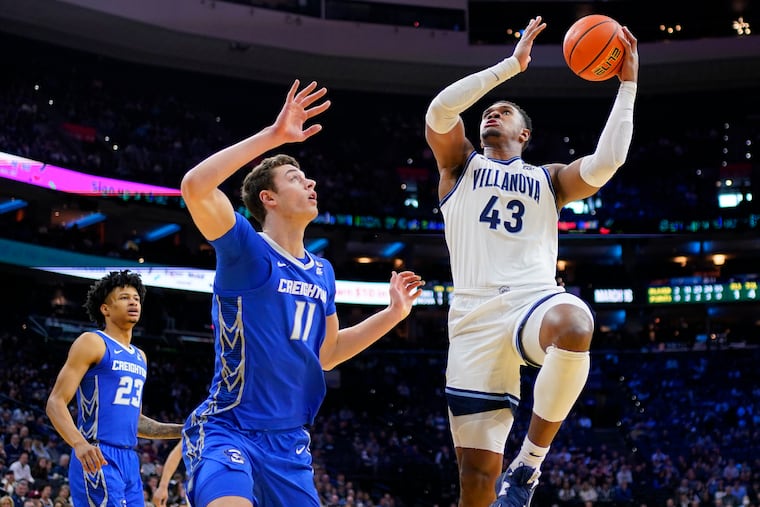 Villanova's Eric Dixon (right) goes up for a shot against Creighton's Ryan Kalkbrenner during the first half Saturday. Dixon's 31 points powered the Wildcats past the Bluejays