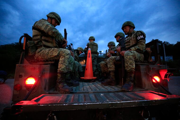 Soldiers forming part of Mexico's National Guard board a truck to patrol back roads used to circumvent a migration checkpoint, in Comitan, Chiapas state, Mexico, Saturday, June 15, 2019. Under pressure from the U.S. to slow the flow of migrants north, Mexico plans to deploy thousands of National Guard troops by Tuesday to its southern border region. (AP Photo/Rebecca Blackwell)